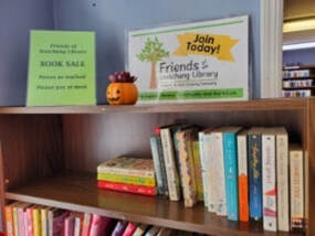Photo of Friends book sale shelf by the library entrance