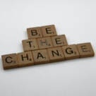 Photo of scrabble letters spelling out Be The Change